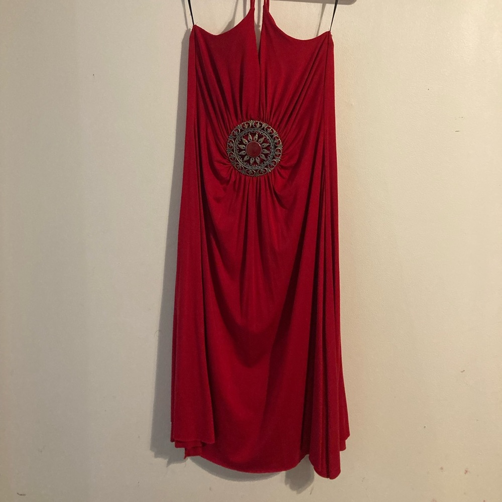 Red strappy dress with metal emblem